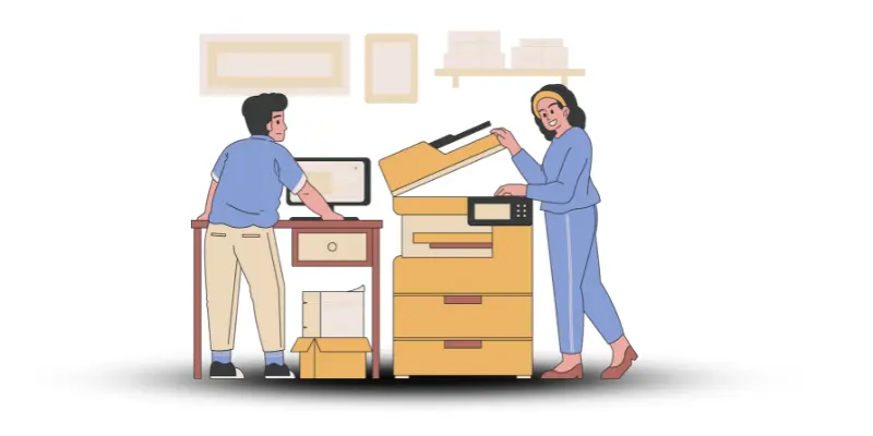 A girl is using a printer while a boy stands next to her, working on a computer to send input to the printer.